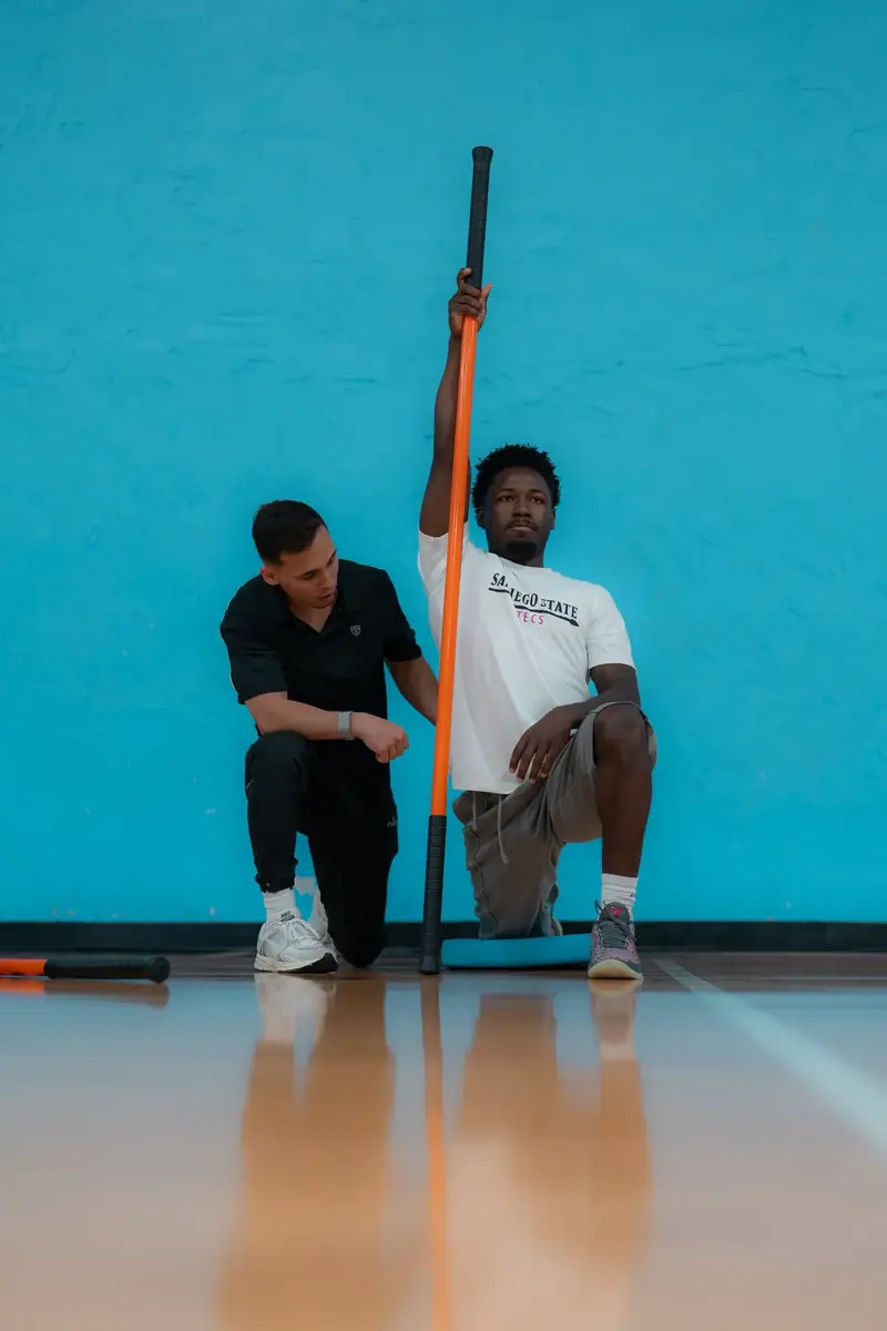 Half-kneeling overhead reach test with a dowel