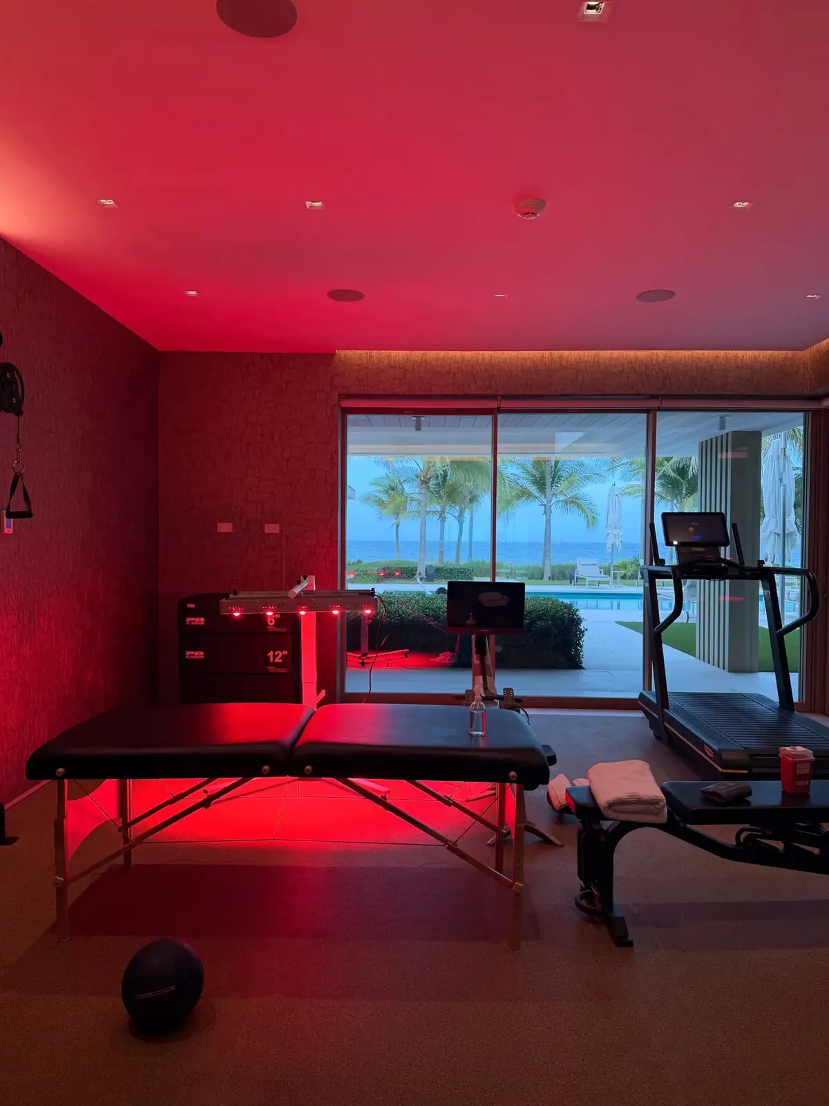 Private home gym prepared for a treatment, ocean view through the windows