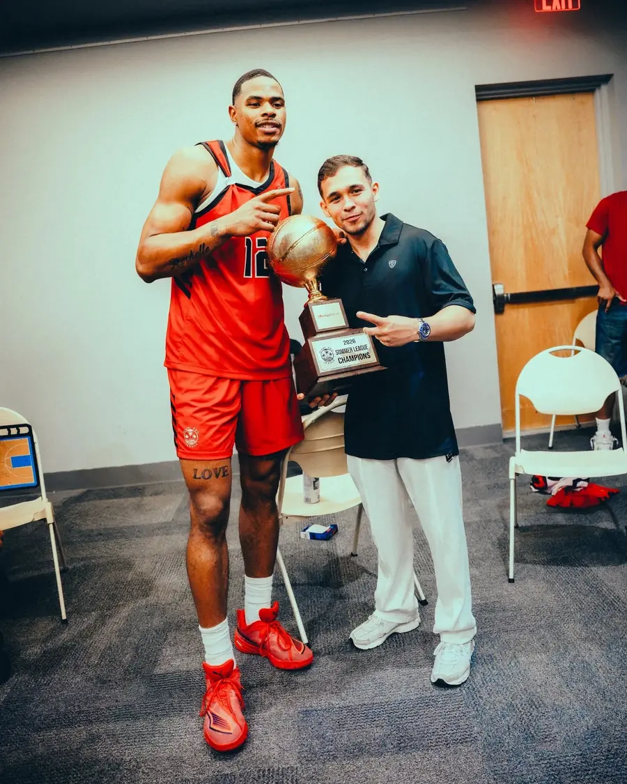 Keshad Johnson holding the 2026 Summer League Champions trophy with Dr. Sierra