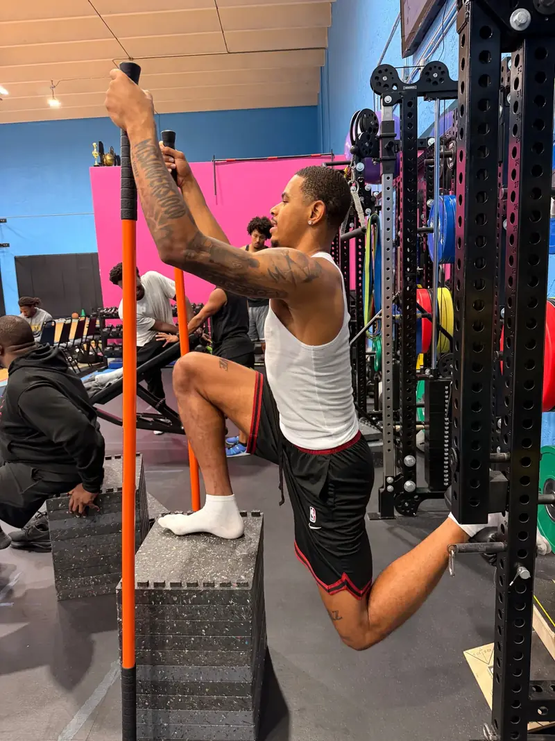 Athlete doing a step-up mobility drill in the gym